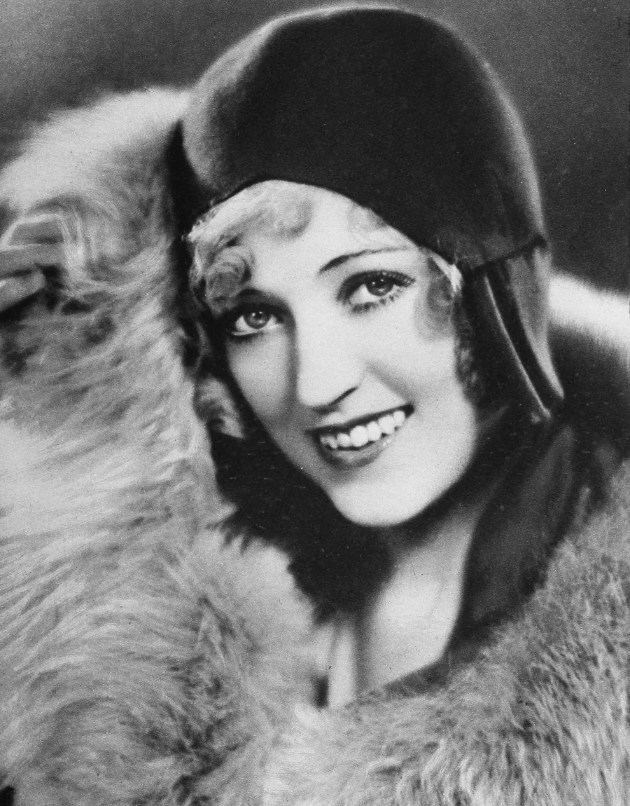 Marion Davies in a dark cloche hat and fur wrap, photographed for Screenland in 1930